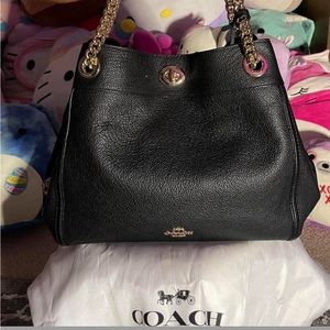black coach bag with gold details